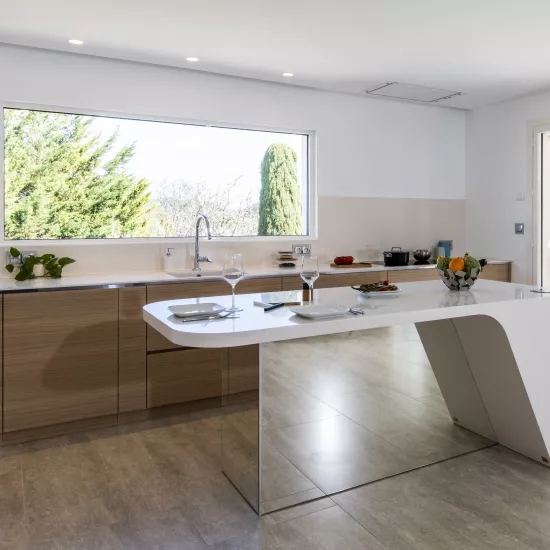 A contemporary, light-filled HIMACS kitchen with a mountain view