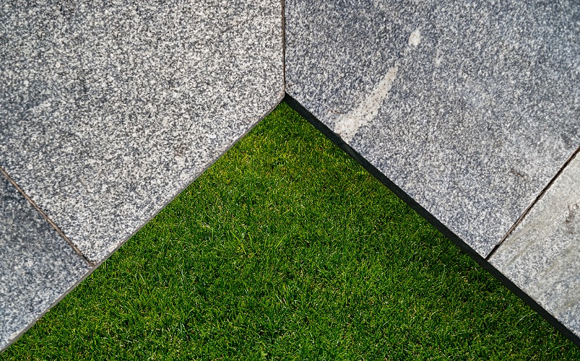 Artificial grass provides a soft and comfortable area to walk on, while the stone adds a sturdy base