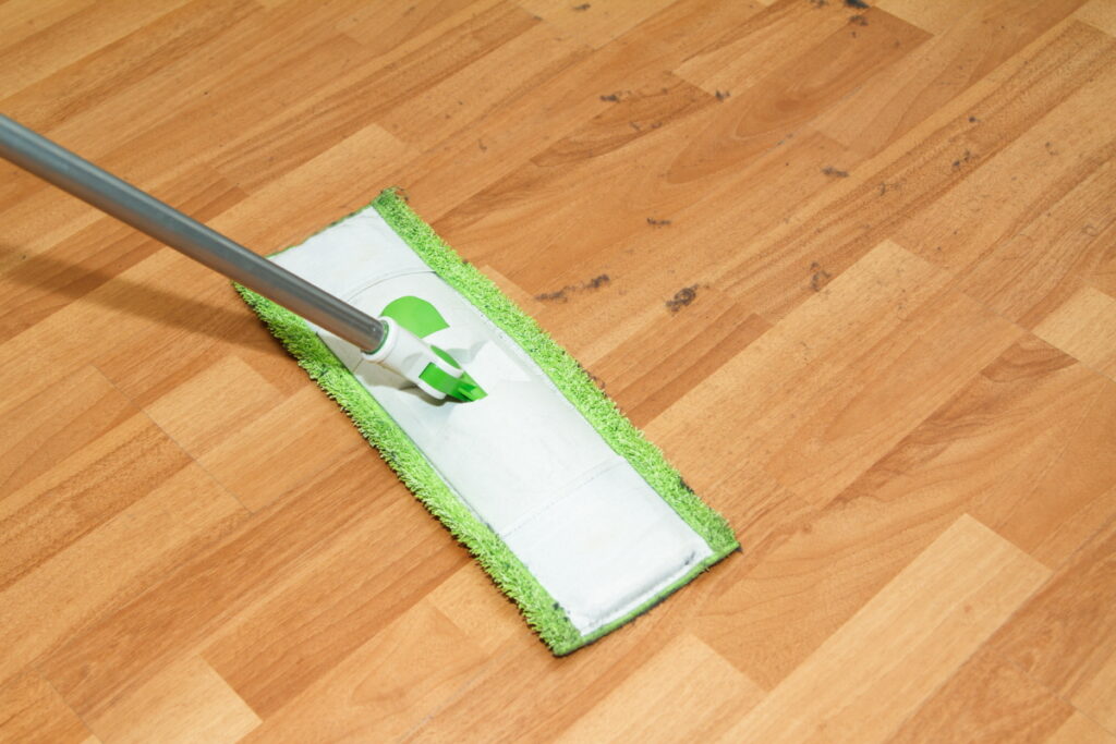 Vinyl and laminate are easy to clean, but vinyl handles water better.