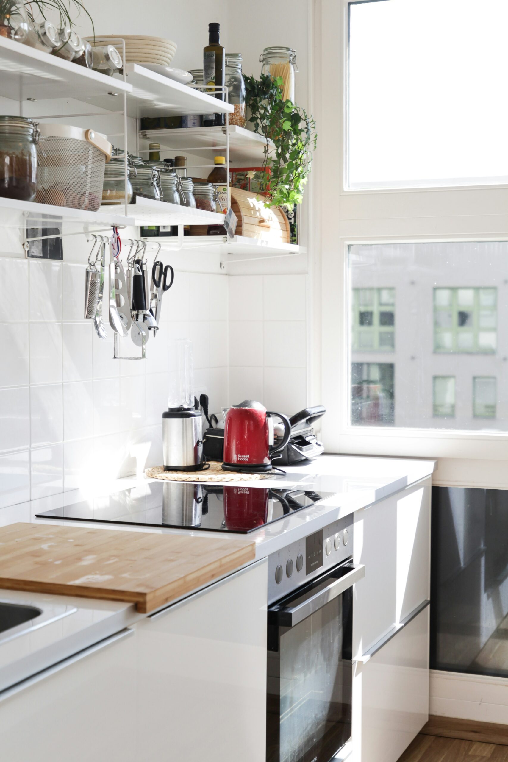 Organize small pantry with drawers, bins, and wall hooks.