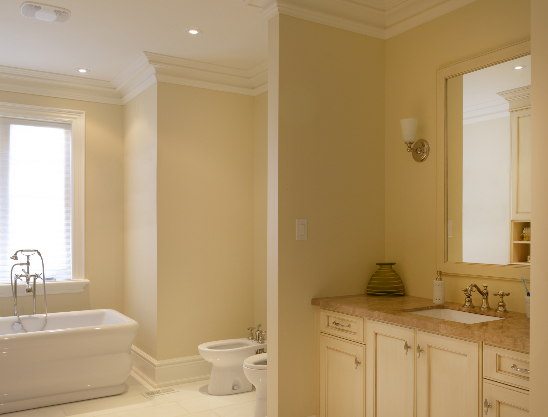 Warm up your guest bathroom with a palette of bright, welcoming tones like soft yellows and warm neutrals.