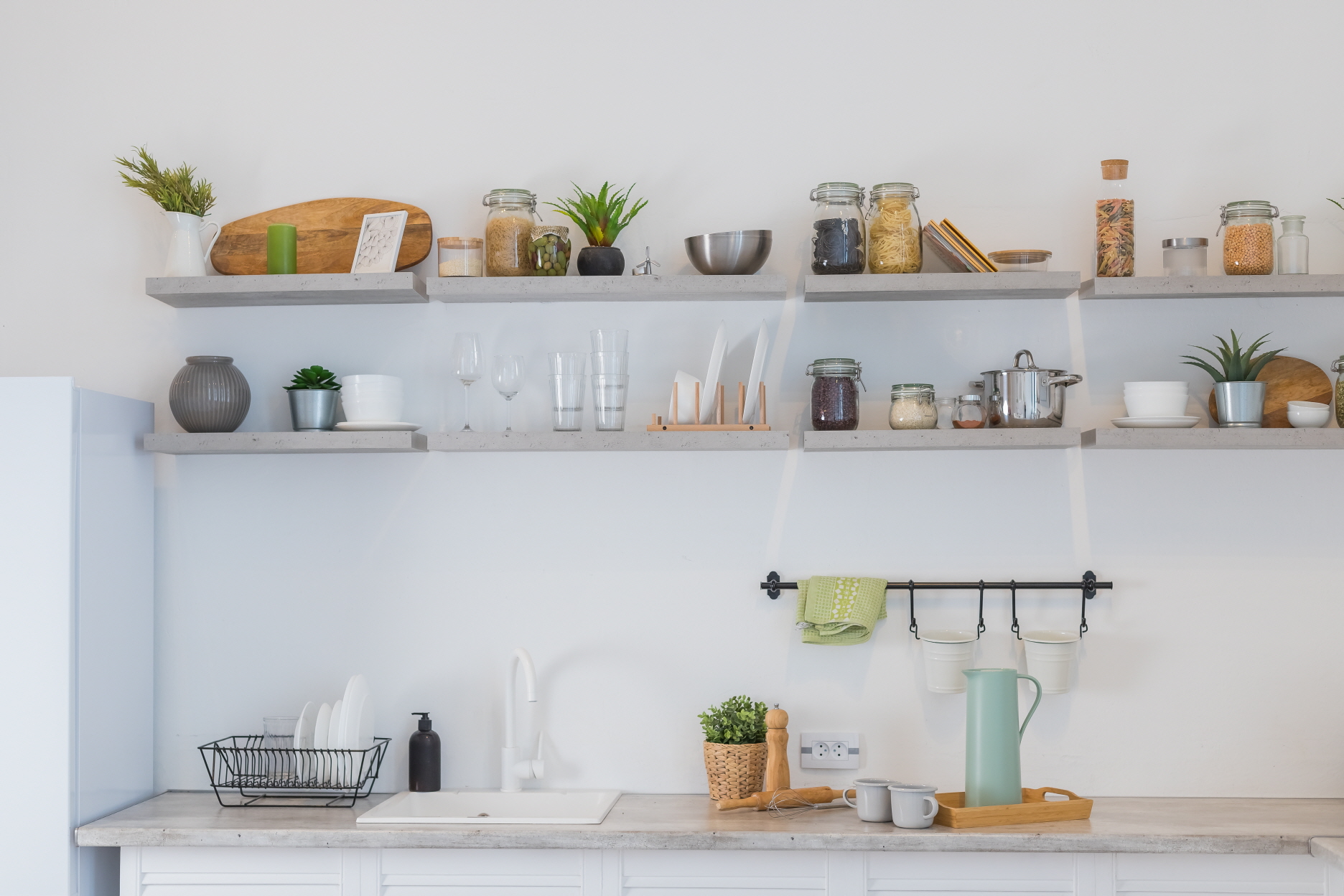 Extra shelving organizes kitchen items, maximizes space, and offers customizable storage options in various materials like wood or metal.