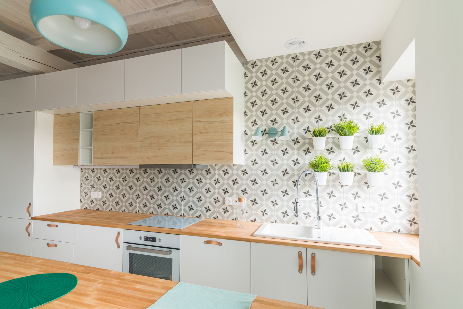 Elevate your small kitchen with bold wallpaper for added depth and focal interest.