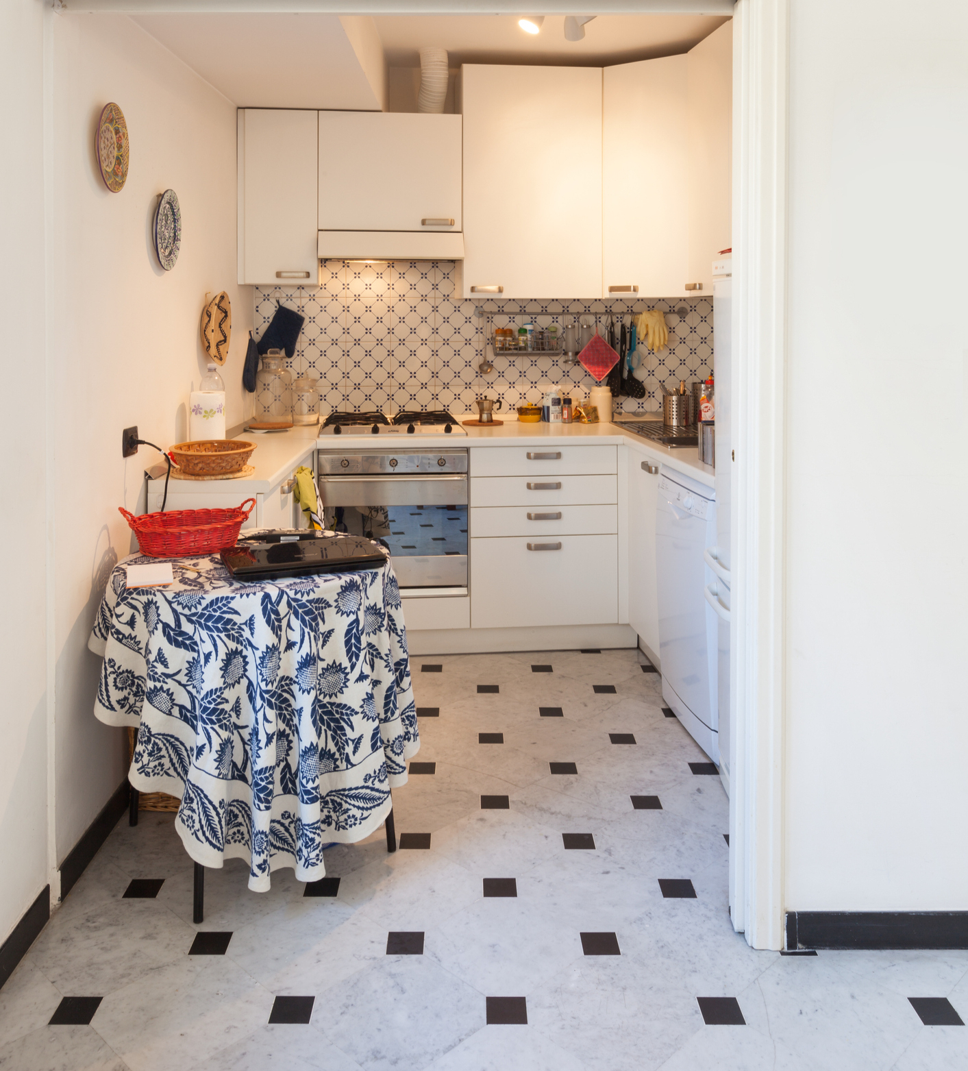 Enhance small kitchens with unique tile patterns for backsplashes and floors.