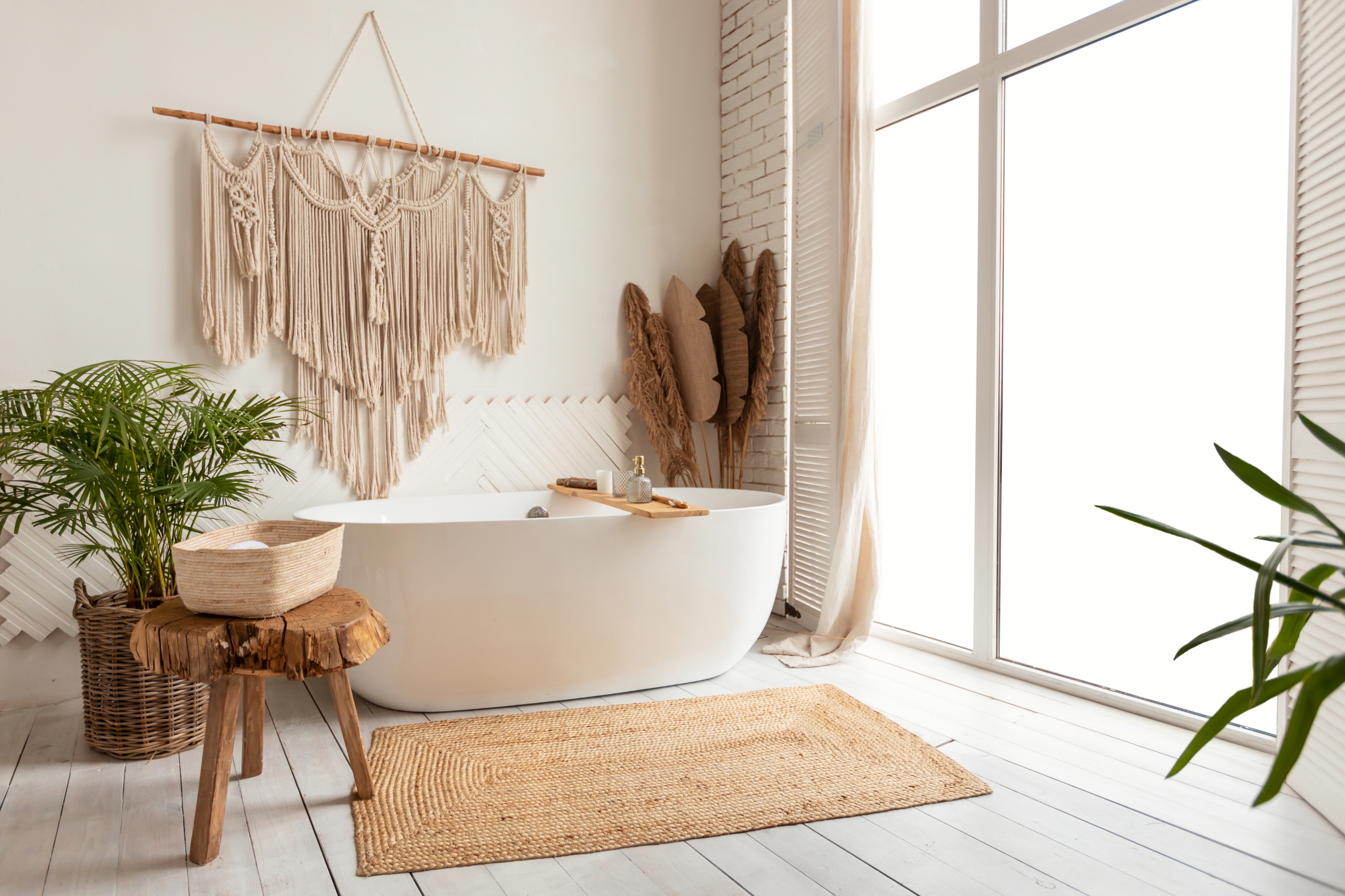 Boho-up your primary bathroom with vibrant colors, eclectic patterns, and natural textures, along with vintage rugs and rattan accents for a relaxed vibe.