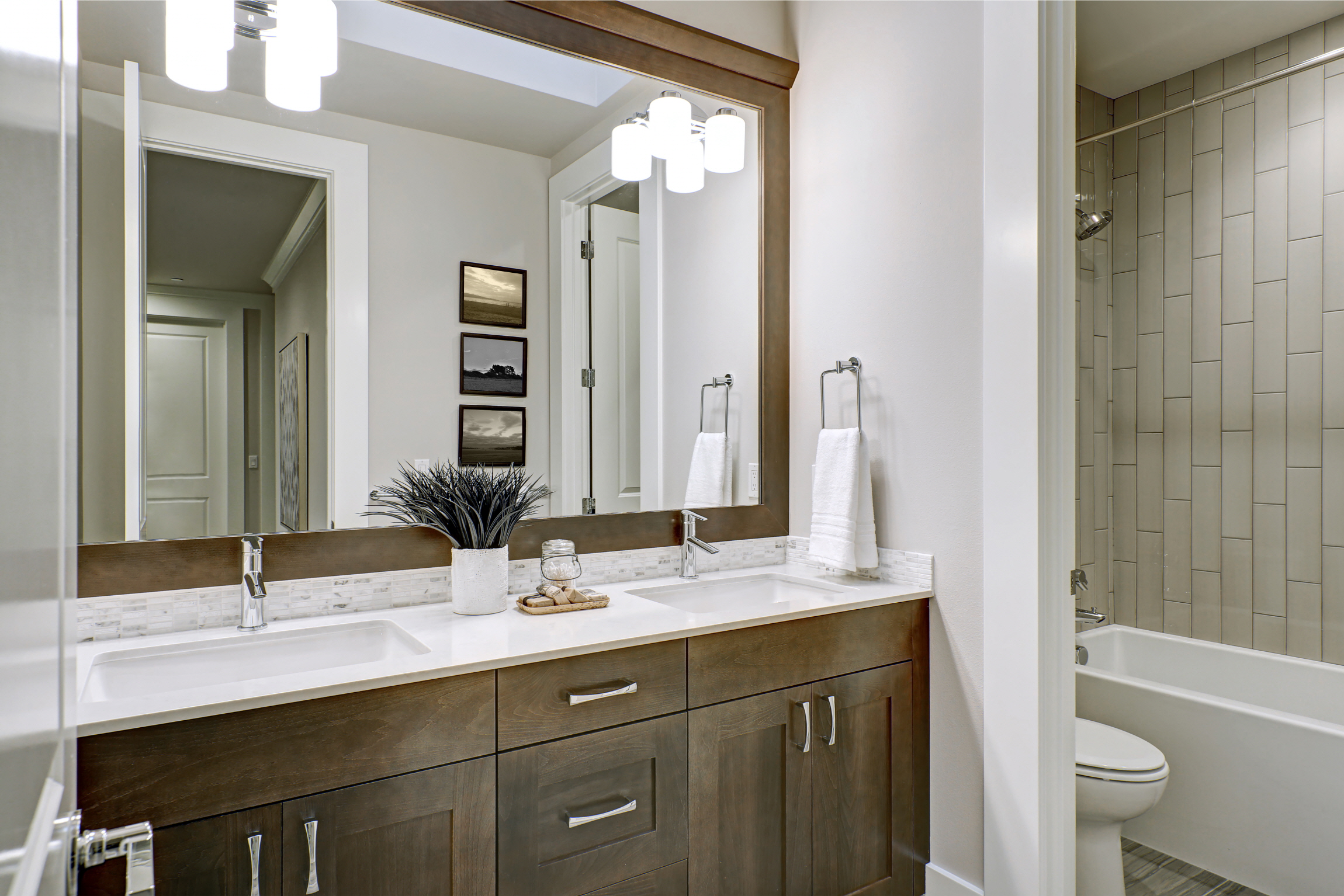 Add warmth to your bathroom with wood accents like a vanity or mirror frame, choosing rich tones for coziness.