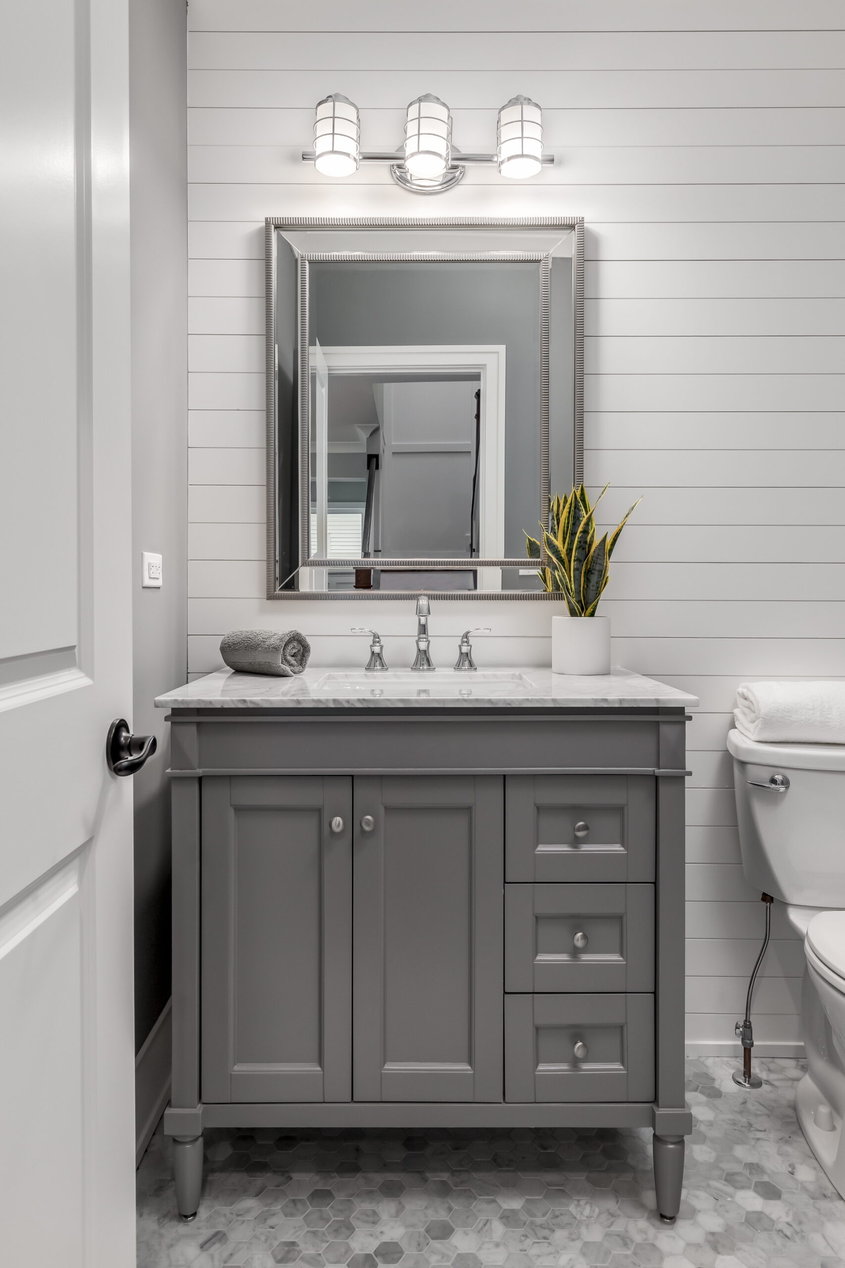 Opt for a vanity with a cabinet below for storage of both toiletries on the top and cleaning supplies below.