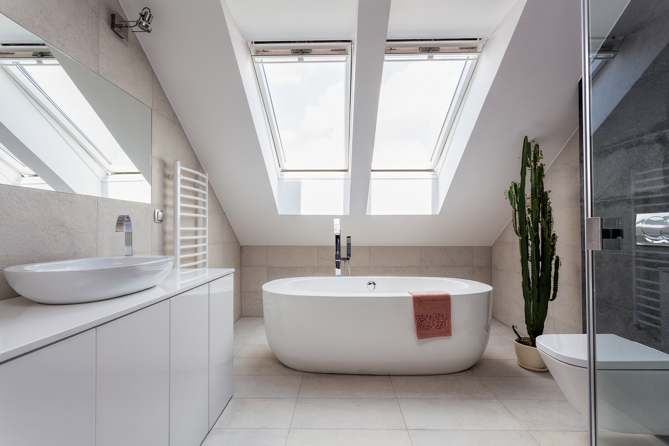 Brighten your bathroom with skylights for a airy feel, enhancing light with mirrors.