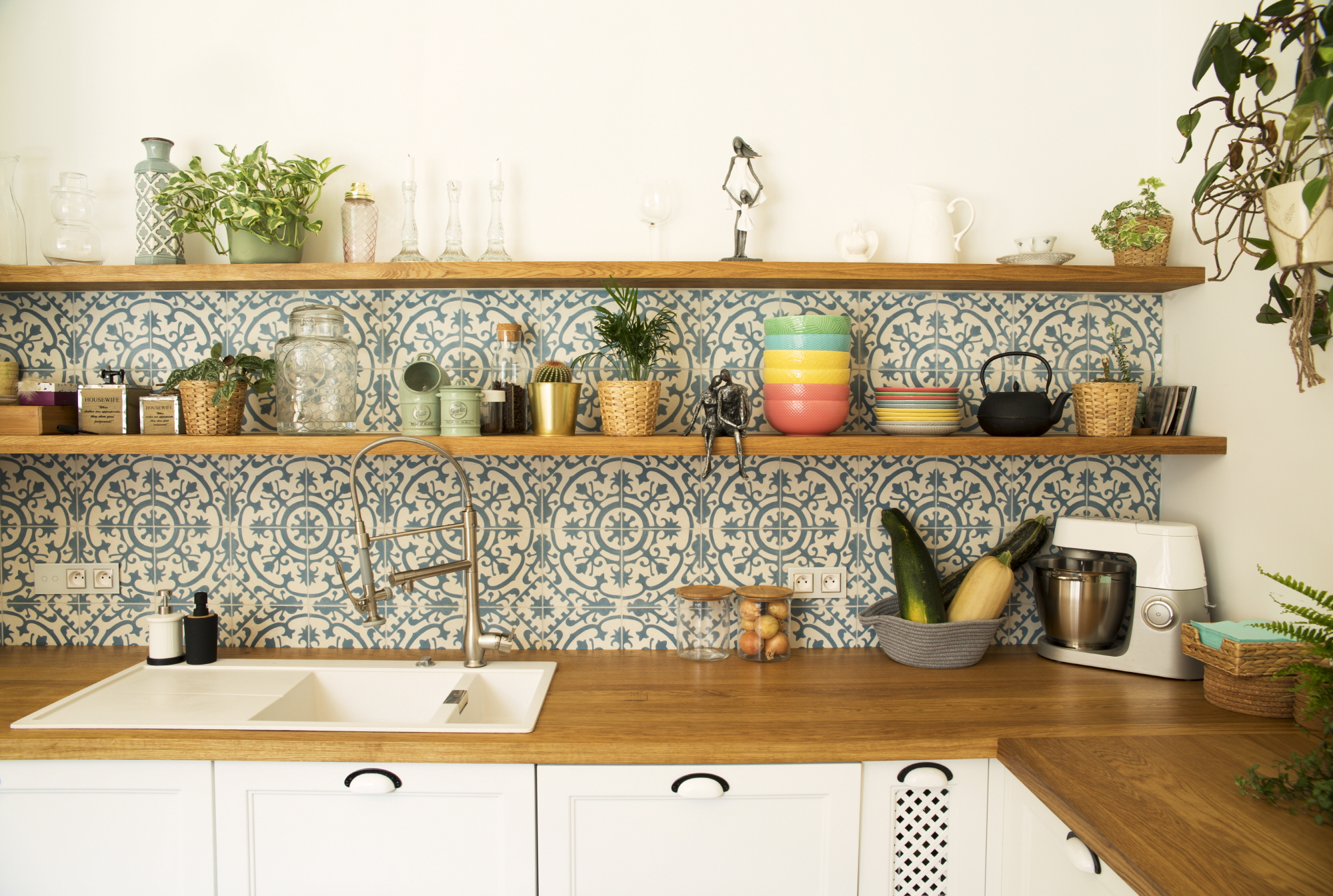 Adopt maximalism in small kitchens with vibrant patterns and warm tones.