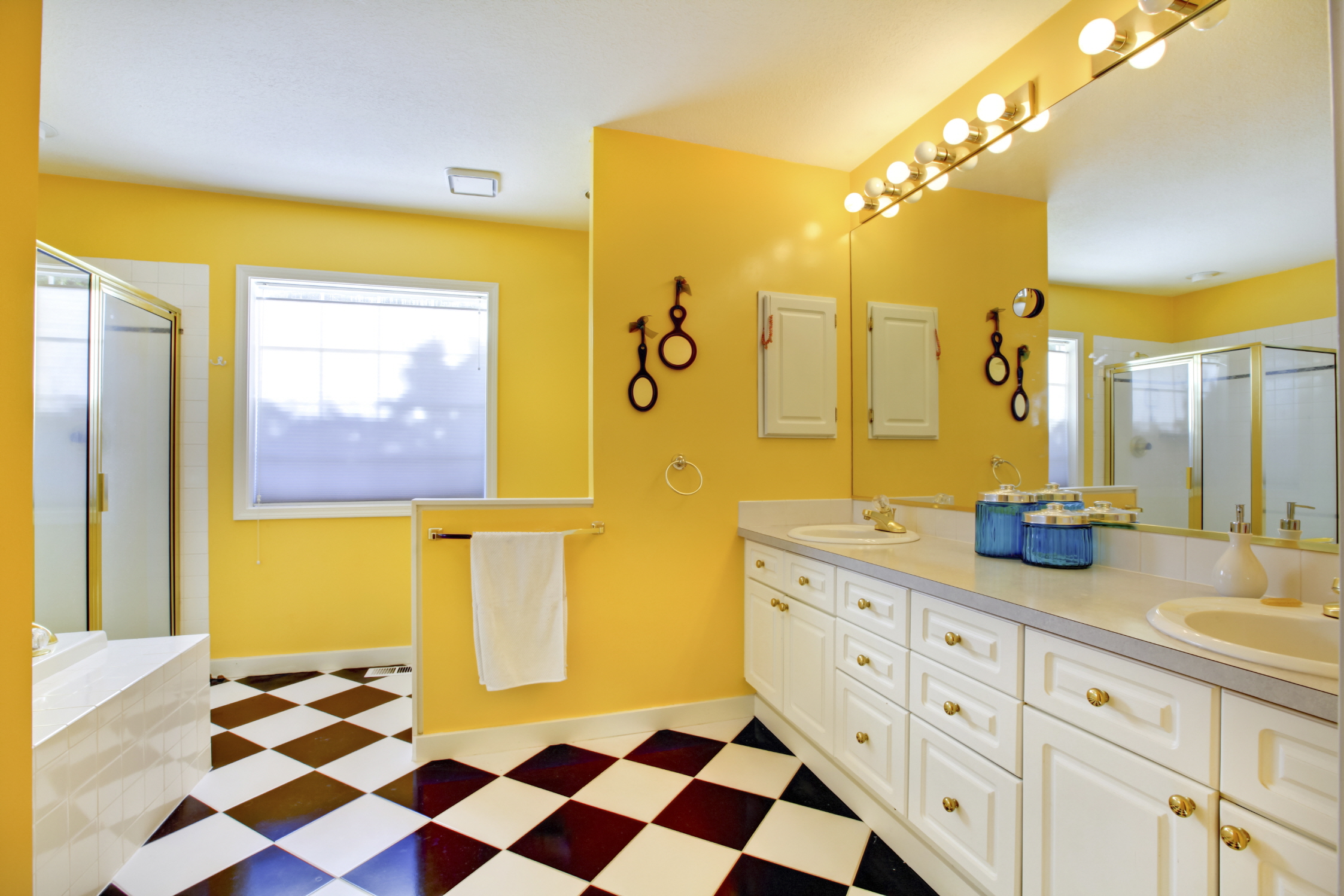Add personality to your bathroom with vibrant paint colors like teal or mustard yellow for a pop of color, and experiment with bold patterns for drama.