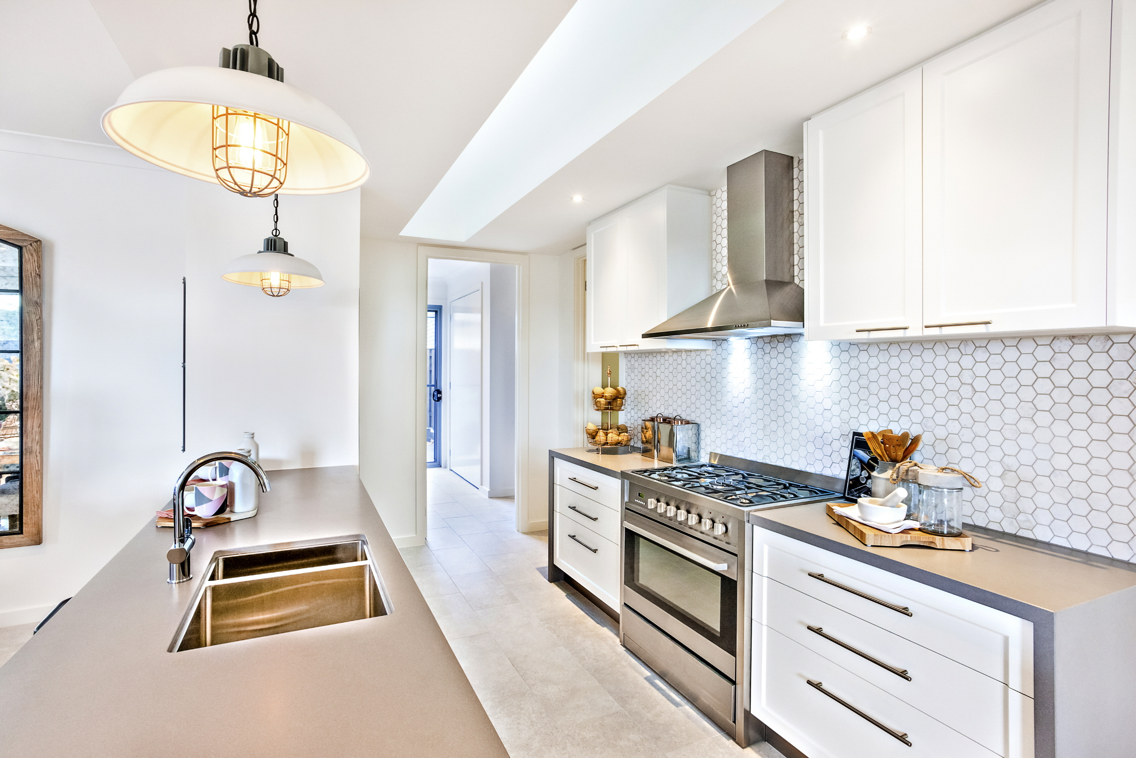 Open up your galley kitchen with open-concept design, clever storage solutions, and light-colored cabinetry for a spacious feel.