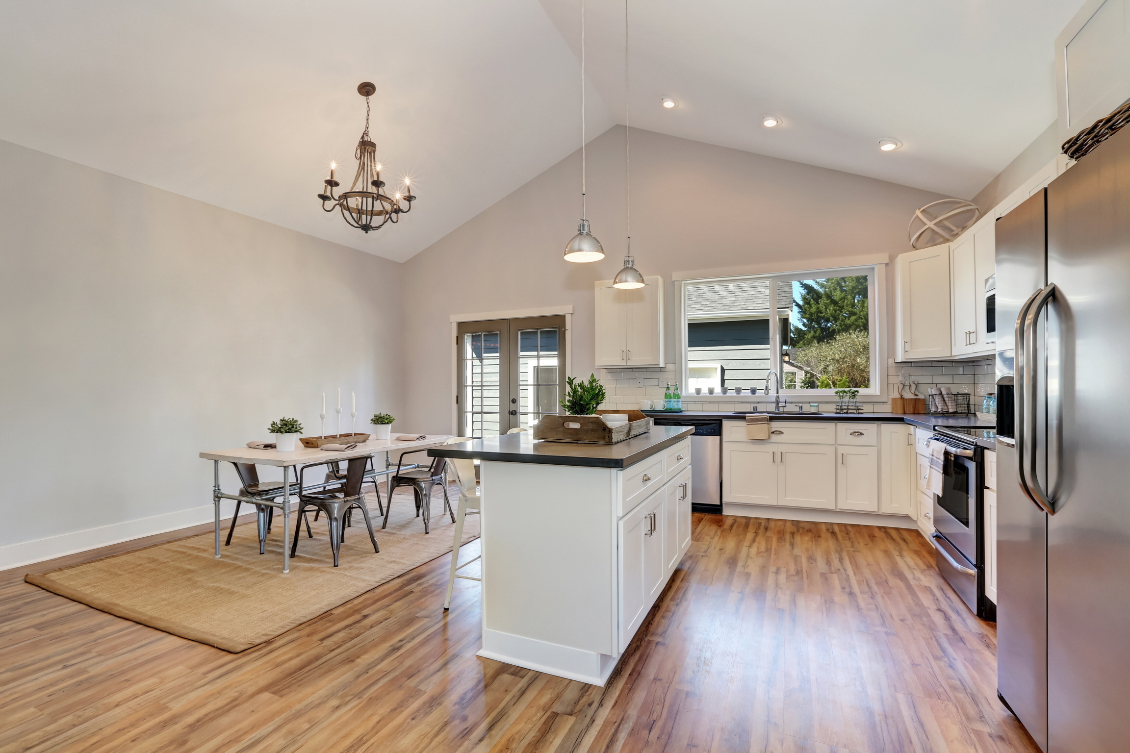 Maximize small open kitchens with light colors, multifunctional furniture, smart storage, and strategic lighting for an intimate feel.