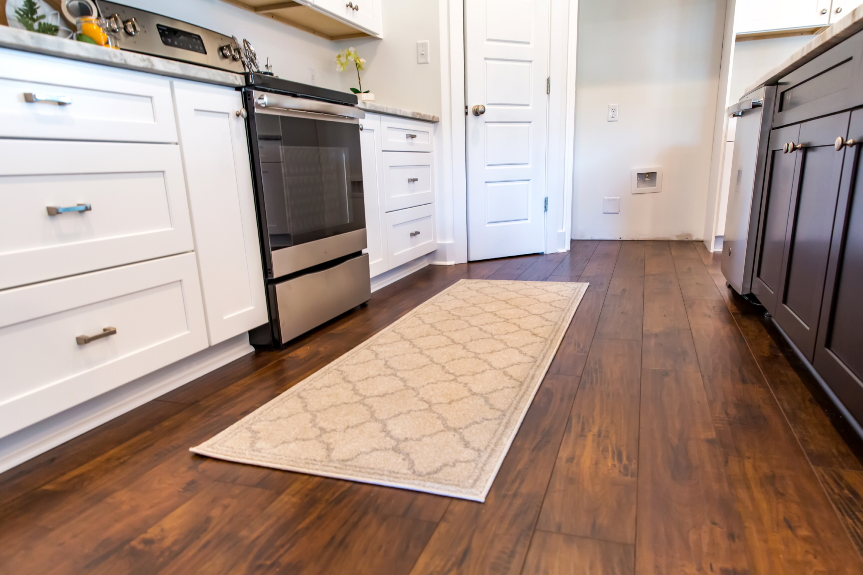LX Hausys flooring with a vibrant rug instantly adds warmth and style to the kitchen.