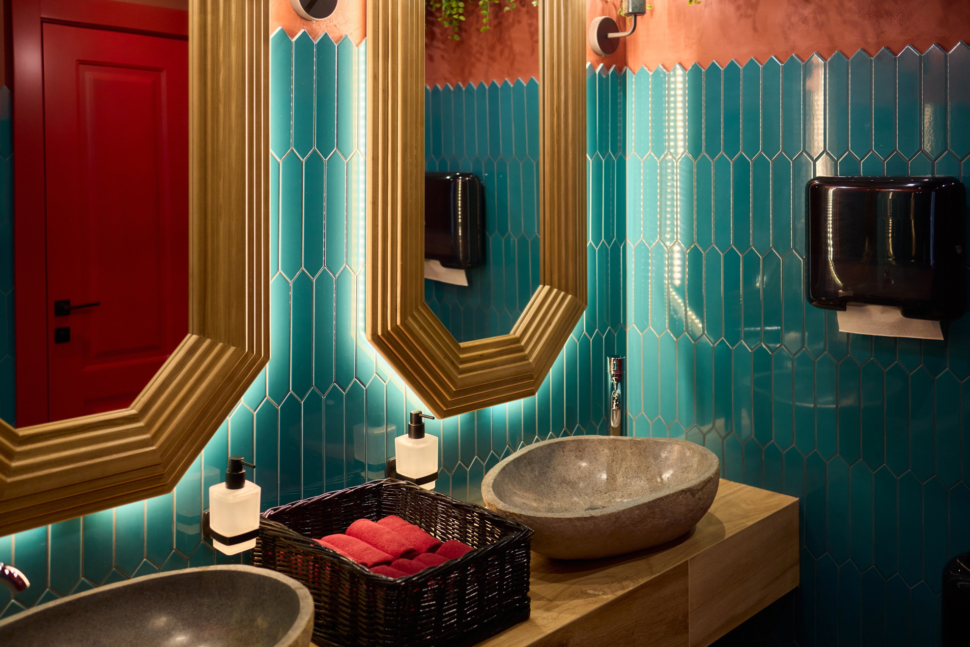 Glossy wood surfaces pair well with antique-style sinks, enhancing the overall aesthetic appeal.